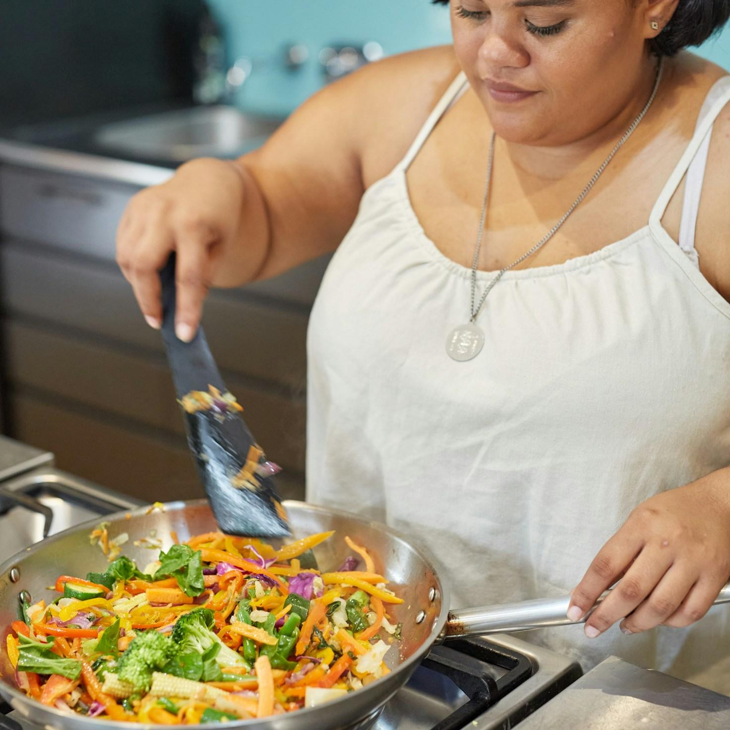 Community members collaborating in a contemporary kitchen, exchanging recipes and techniques